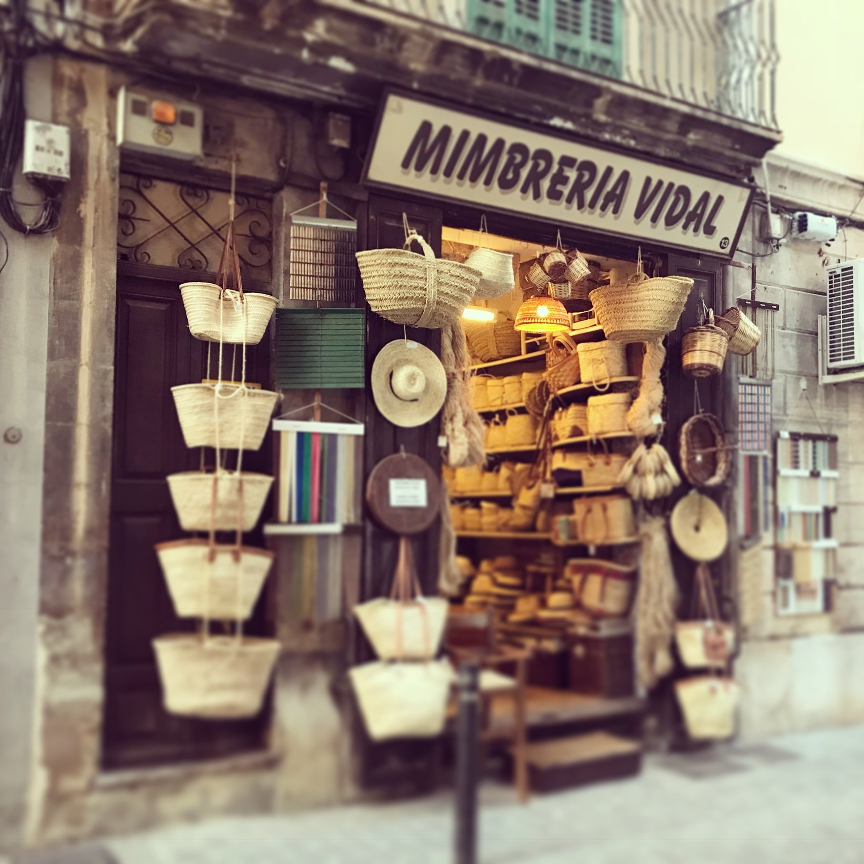 The entrance to Mimbrería Vidal in Palma, with woven baskets hanging around the doorway.
